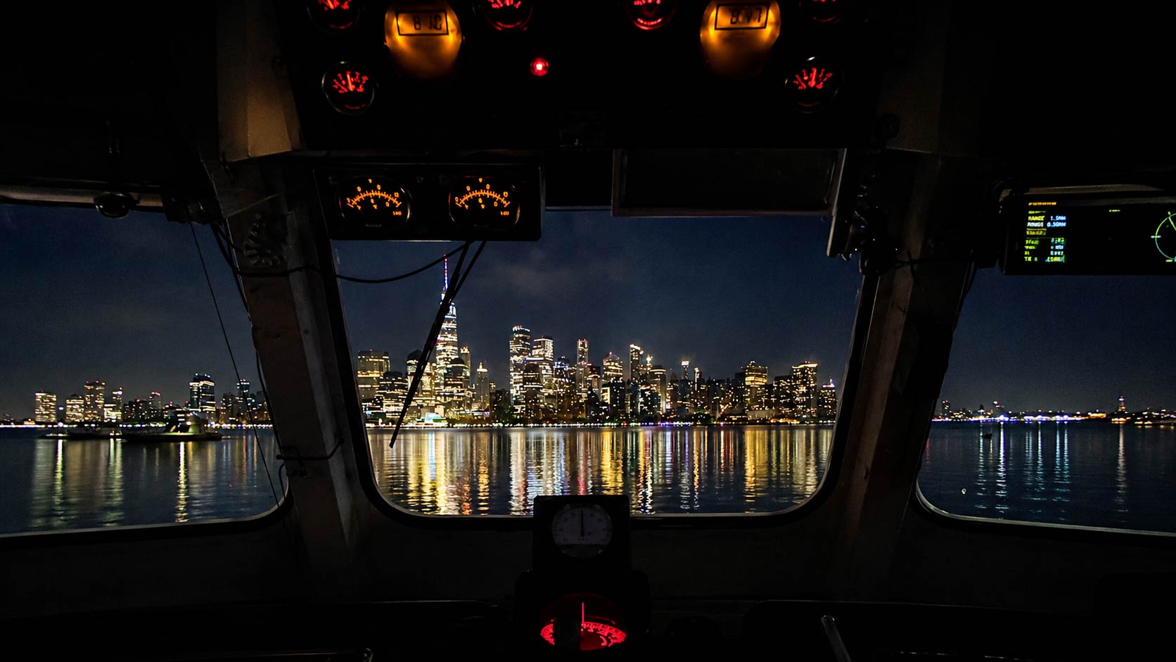 Guests taking photos during a NYC night cruise